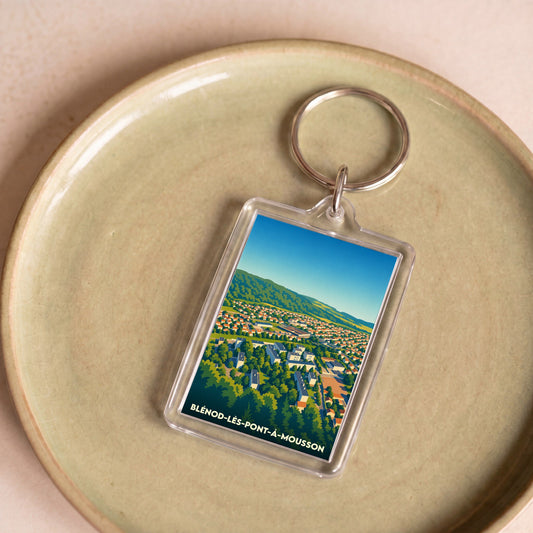 Porte-clés souvenir de la ville de Blénod-lès-Pont-à-Mousson avec une illustration stylisée.