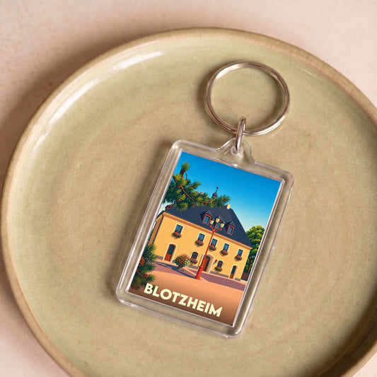 Porte-clés souvenir de la ville de Blotzheim avec une illustration stylisée.