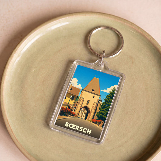 Porte-clés souvenir de la ville de Bœrsch avec une illustration stylisée de sa porte fortifiée.
