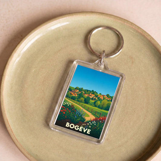 Porte-clés souvenir de la ville de Bogève avec une illustration stylisée de son paysage champêtre.