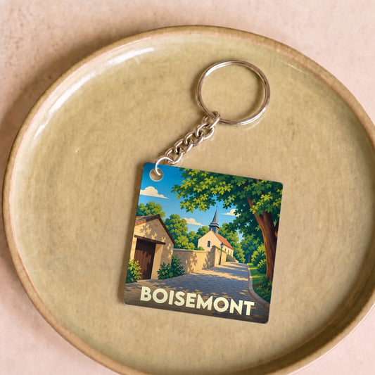 Porte-clés souvenir de la ville de Boisemont avec une illustration stylisée d'une rue pittoresque.