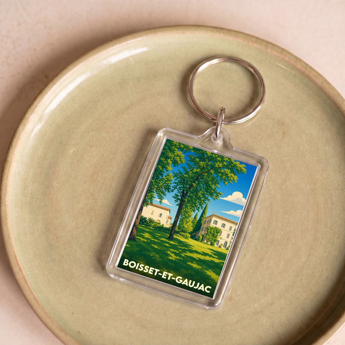 Porte-clés souvenir de la ville de Boisset-et-Gaujac avec une illustration stylisée d'un domaine arboré.
