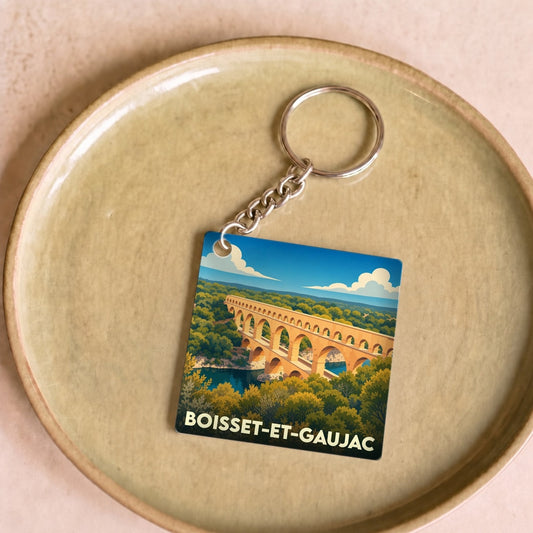 Porte-clés souvenir de la ville de Boisset-et-Gaujac avec une illustration stylisée d'un pont en pierre.