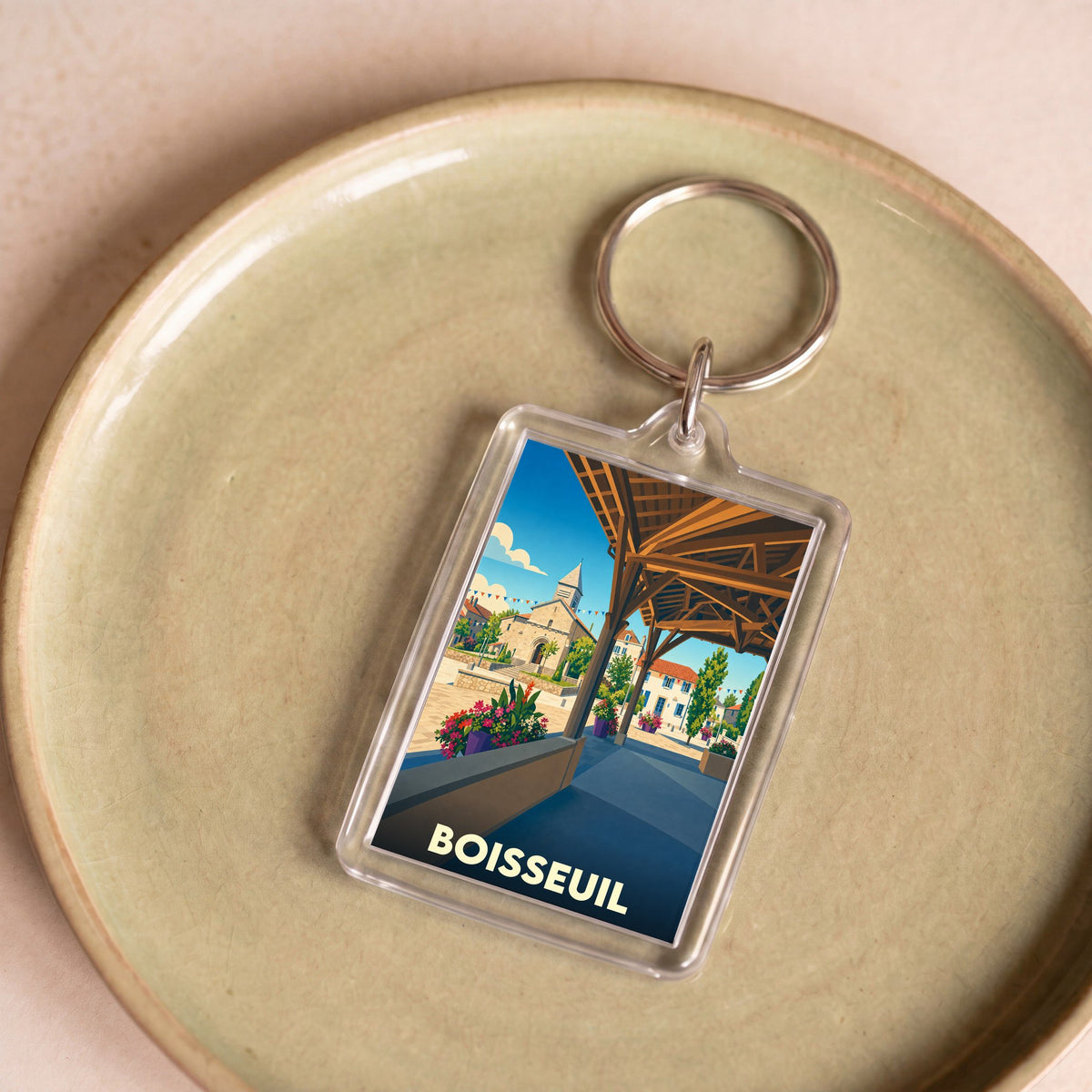 Porte-clés souvenir de la ville de Boisseuil avec une illustration stylisée.