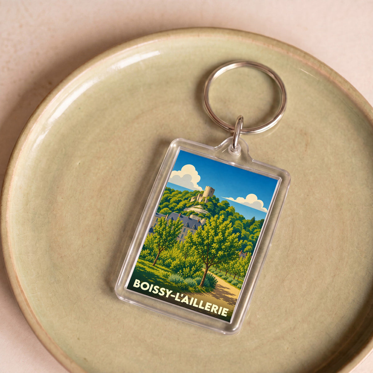 Porte-clés souvenir de la ville de Boissy-l'Aillerie avec une illustration stylisée d'un paysage local.