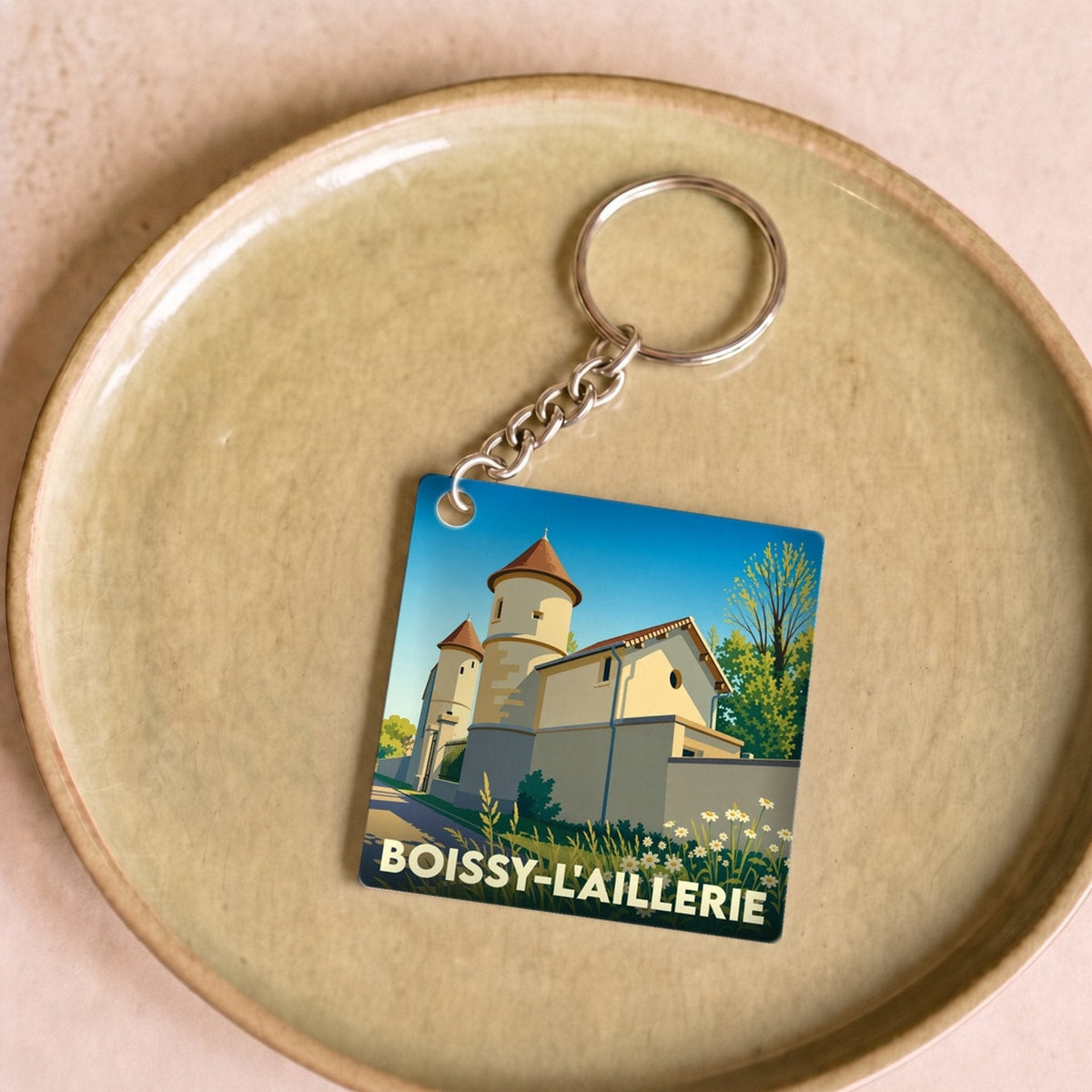 Porte-clés souvenir de la ville de Boissy-l'Aillerie avec une illustration stylisée de son patrimoine.