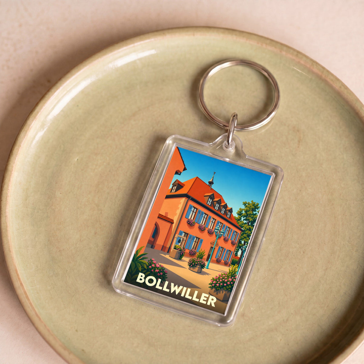 Porte-clés souvenir de la ville de Bollwiller avec une illustration stylisée.