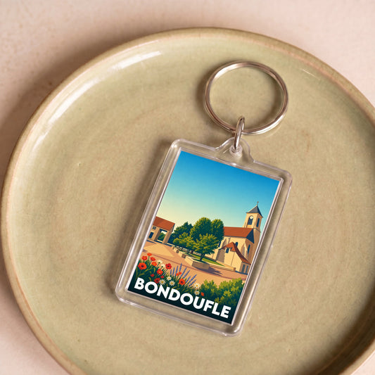 Porte-clés souvenir de la ville de Bondoufle avec une illustration colorée et stylisée.