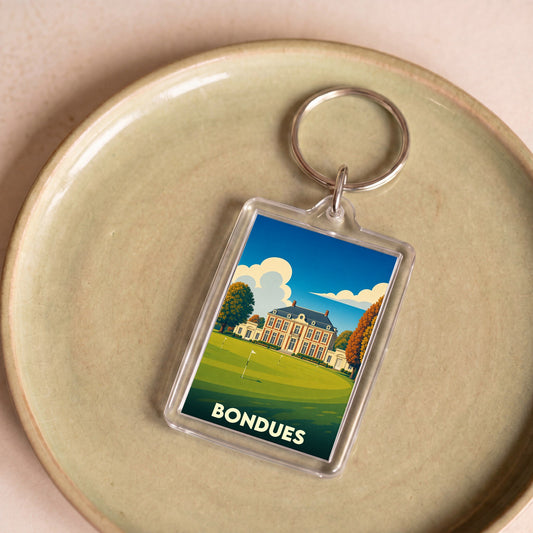 Porte-clés souvenir de la ville de Bondues avec une illustration stylisée d'un château sur un golf.