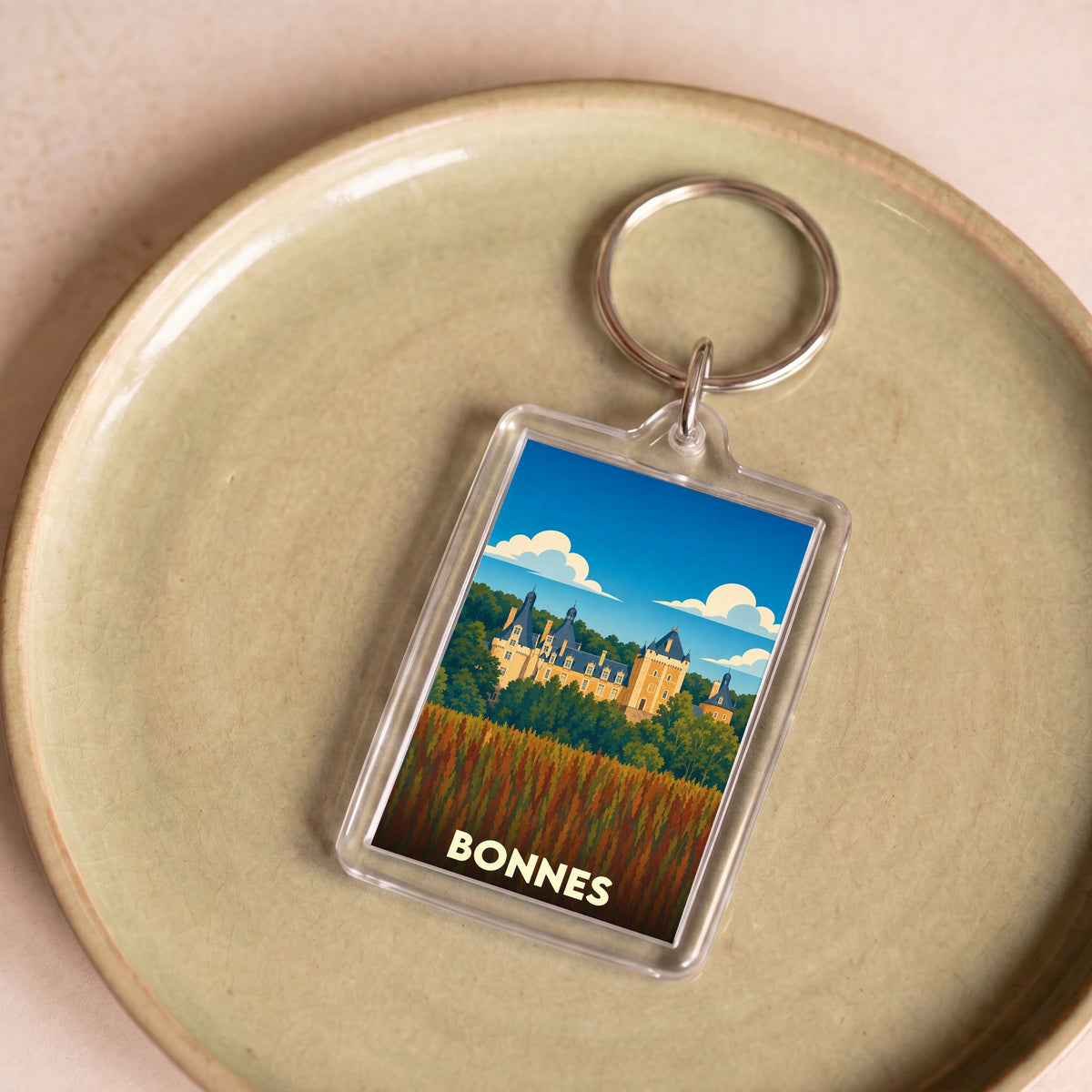 Porte-clés souvenir de la ville de Bonnes avec une illustration stylisée d'un château.