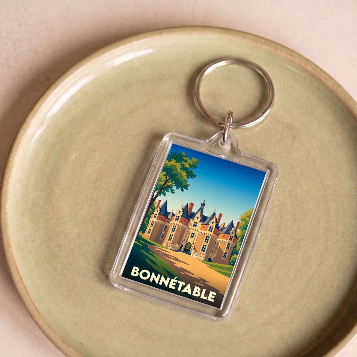 Porte-clés souvenir de la ville de Bonnétable avec une illustration stylisée de son château.