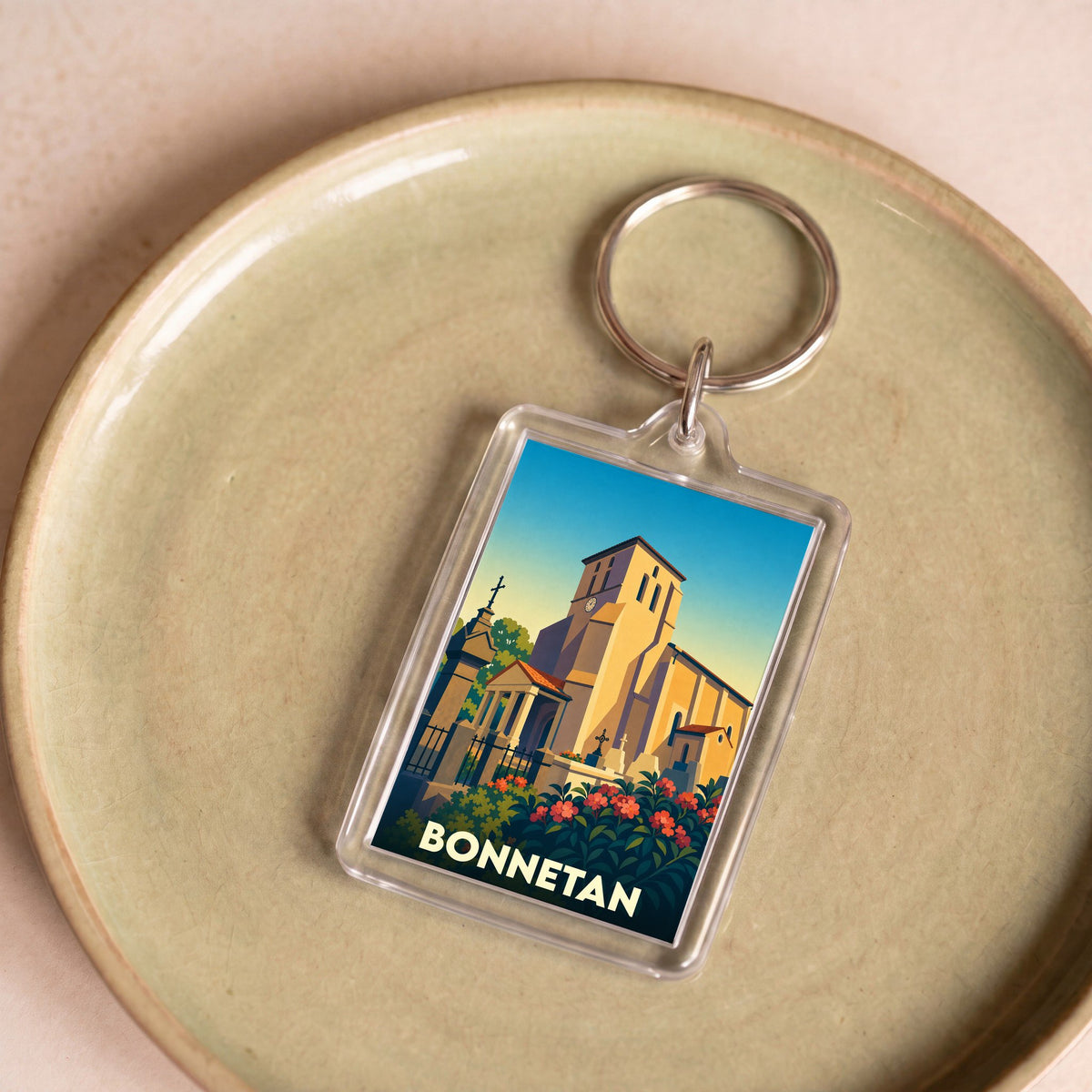 Porte-clés souvenir de la ville de Bonnetan avec une illustration stylisée de son église.