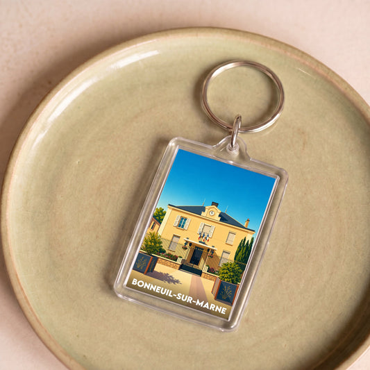 Porte-clés souvenir de la ville de Bonneuil-sur-Marne avec une illustration stylisée d'un bâtiment.