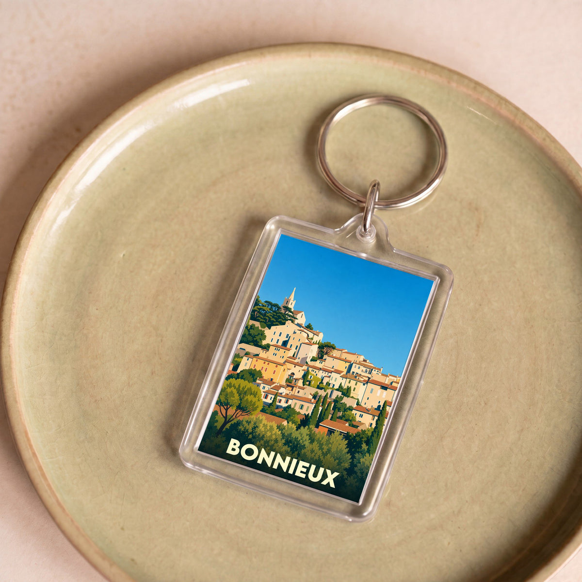 Porte-clés souvenir de la ville de Bonnieux avec une illustration stylisée.