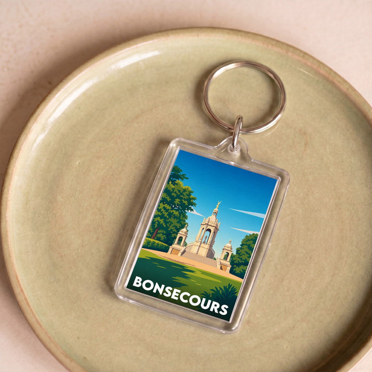 Porte-clés souvenir de la ville de Bonsecours avec une illustration stylisée d'un monument historique.