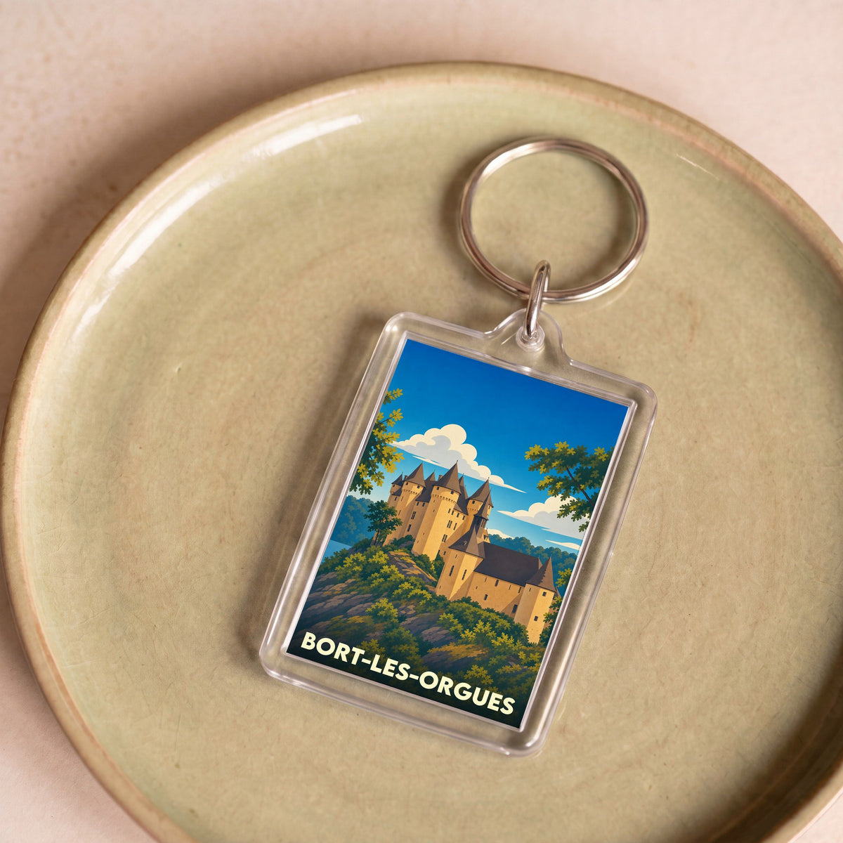 Porte-clés souvenir de la ville de Bort-les-Orgues avec une illustration stylisée de son château.