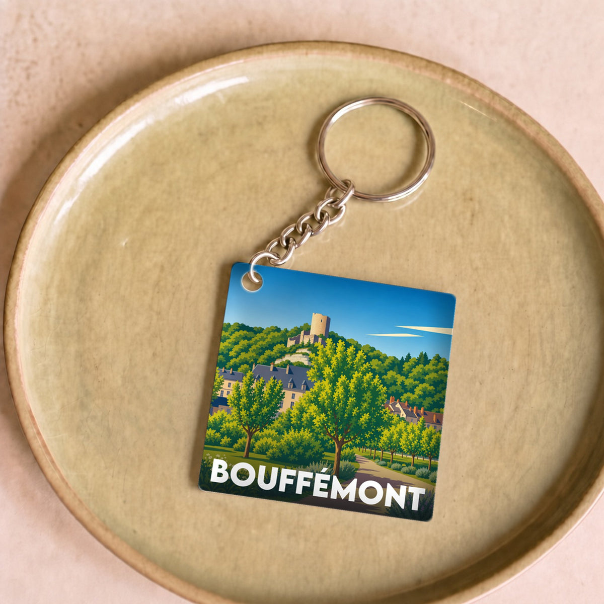 Porte-clés souvenir de la ville de Bouffémont avec une illustration stylisée.