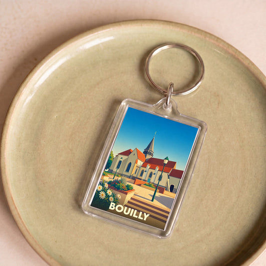 Porte-clés souvenir de la ville de Bouilly avec une illustration stylisée de son église.