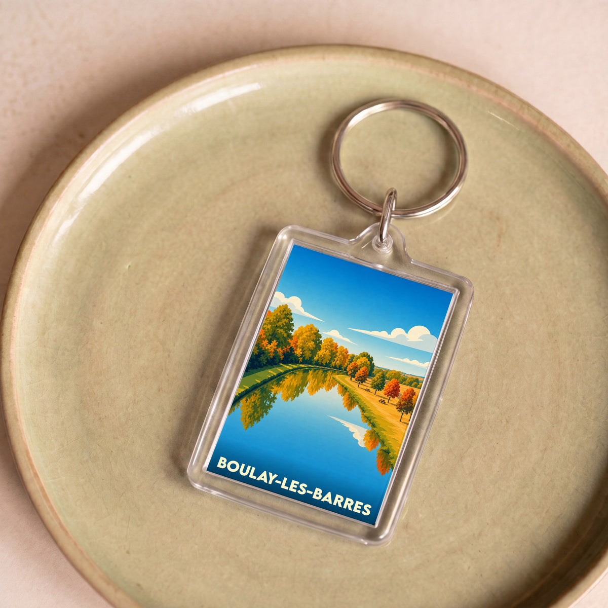 Porte-clés souvenir de la ville de Boulay-les-Barres avec une illustration automnale stylisée.