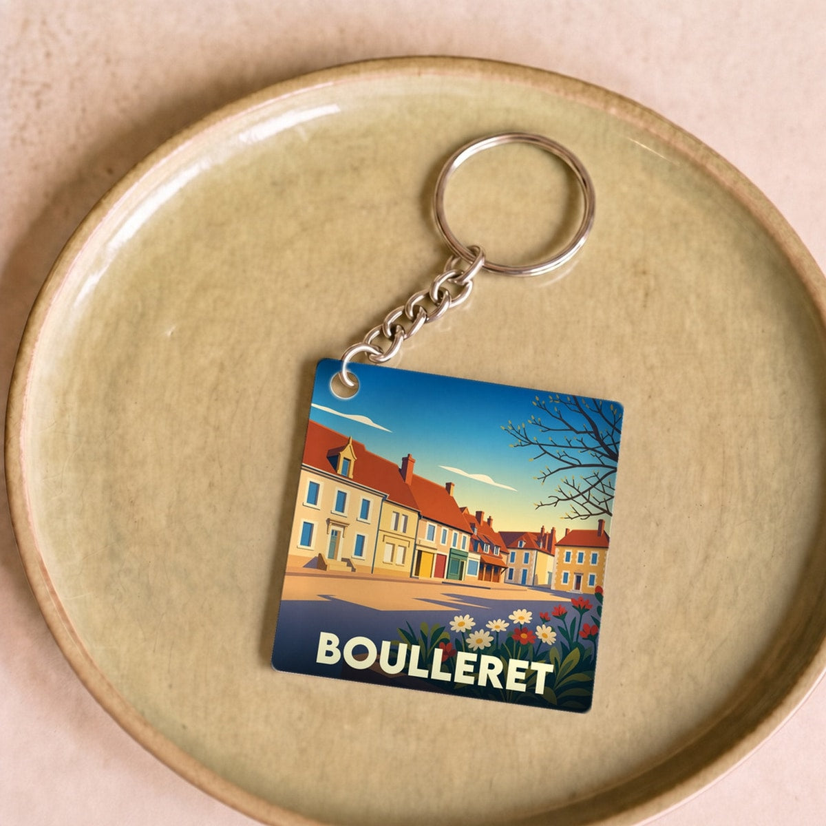 Porte-clés souvenir de la ville de Boulleret avec une illustration stylisée.