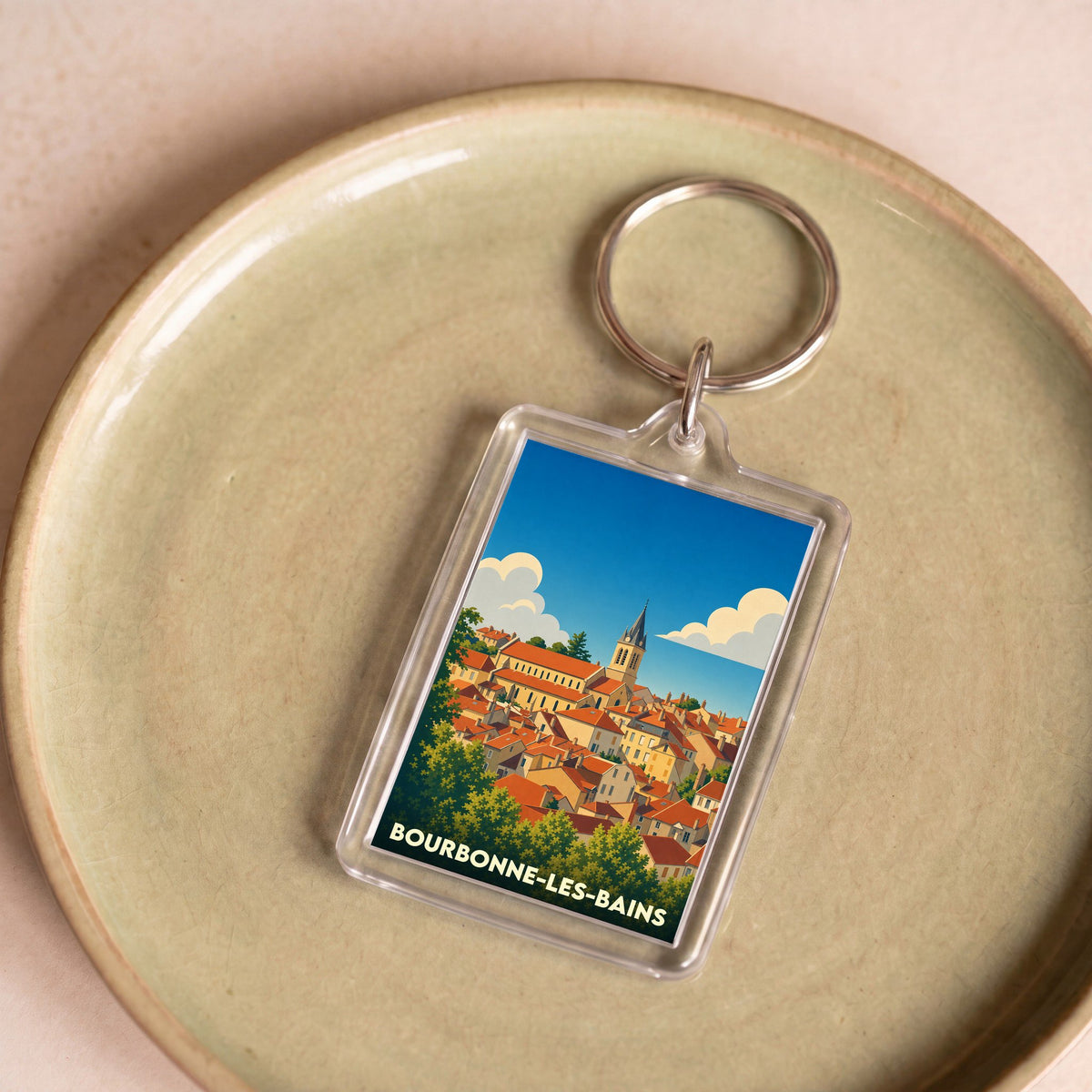 Porte-clés souvenir de la ville de Bourbonne-les-Bains avec une illustration stylisée.