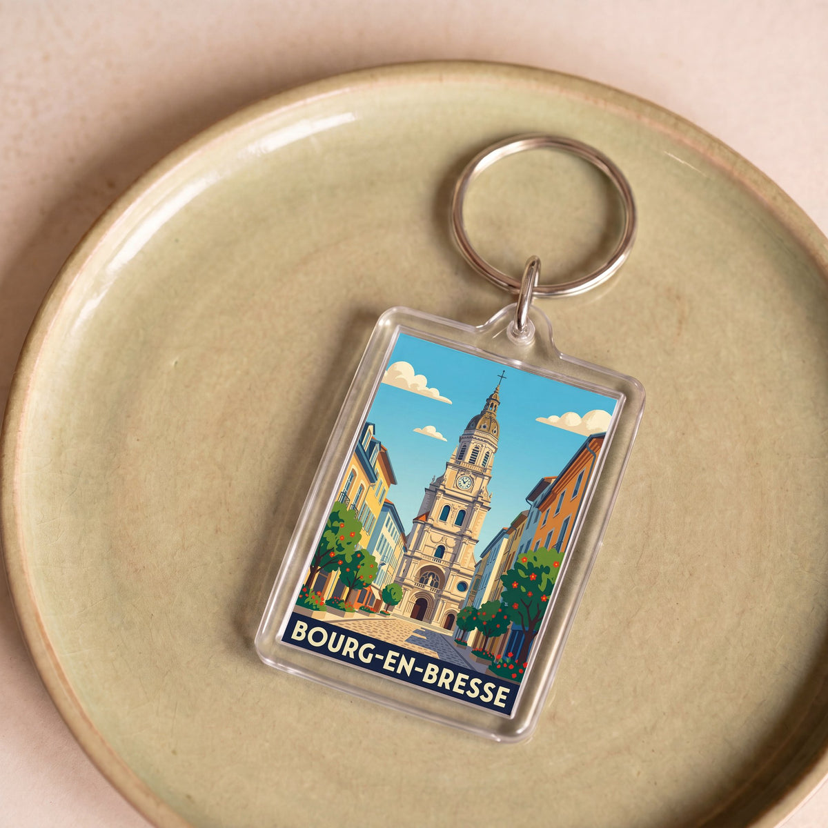 Porte-clés souvenir de la ville de Bourg-en-Bresse avec une illustration stylisée.