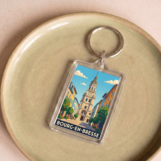 Porte-clés souvenir de la ville de Bourg-en-Bresse avec une illustration stylisée.