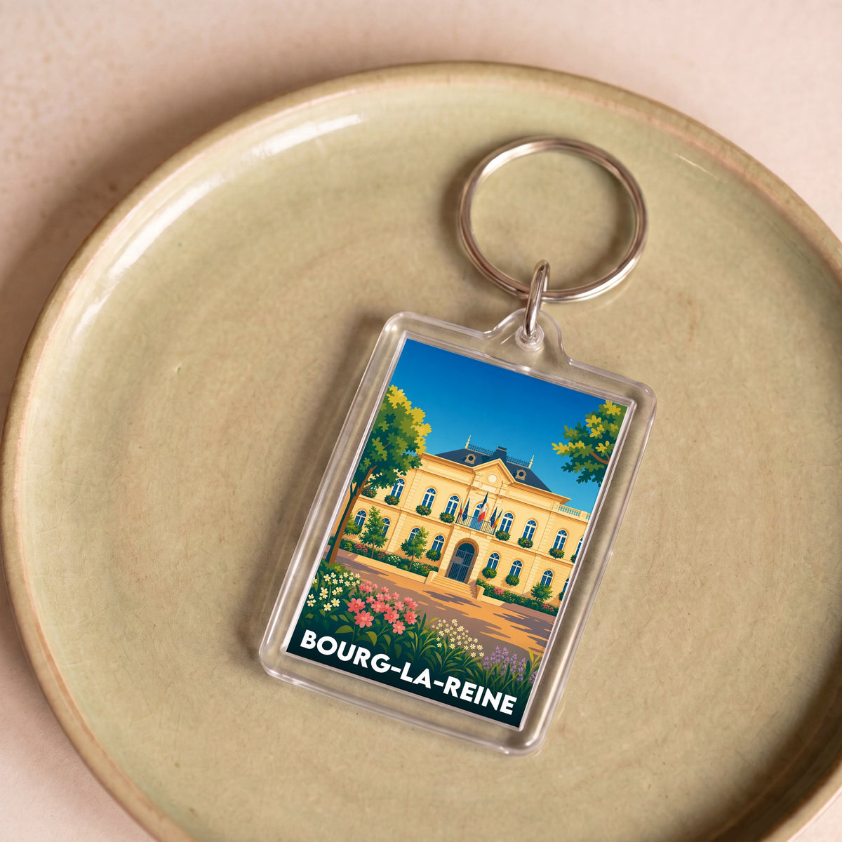 Porte-clés souvenir de la ville de Bourg-la-Reine avec une illustration stylisée.