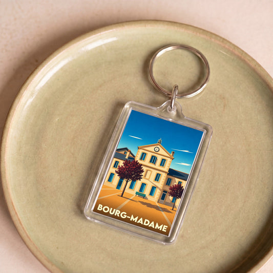 Porte-clés souvenir de la ville de Bourg-Madame avec une illustration stylisée.