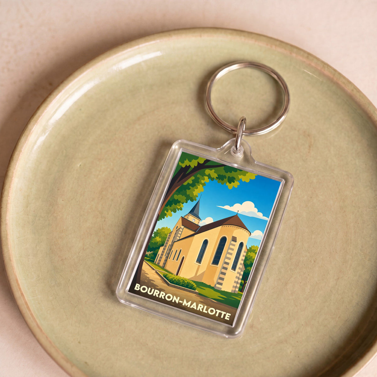 Porte-clés souvenir de la ville de Bourron-Marlotte avec une illustration stylisée de son église.