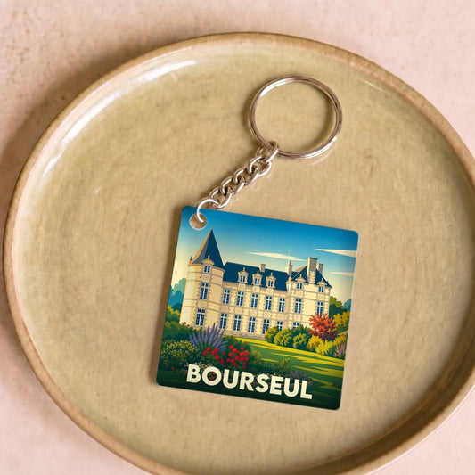 Porte-clés souvenir de la ville de Bourseul avec une illustration stylisée d'un château.