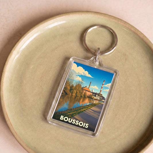 Porte-clés souvenir de la ville de Boussois avec une illustration stylisée de son paysage industriel au bord de l'eau.