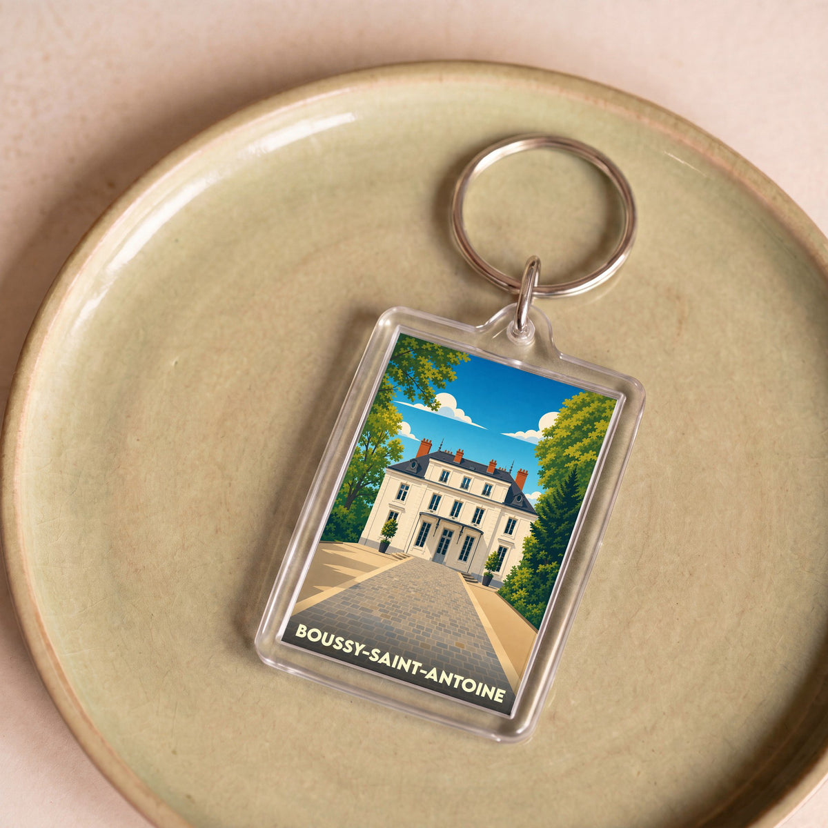 Porte-clés souvenir de la ville de Boussy-Saint-Antoine avec une illustration stylisée.