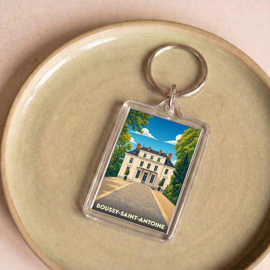 Porte-clés souvenir de la ville de Boussy-Saint-Antoine avec une illustration stylisée.
