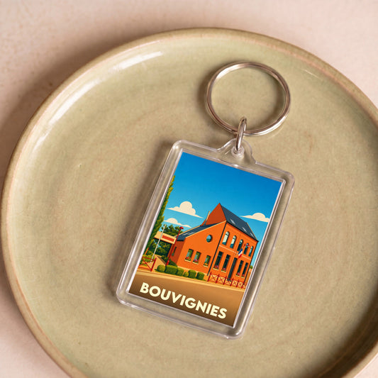 Porte-clés souvenir de la ville de Bouvignies avec une illustration stylisée d'un bâtiment local.