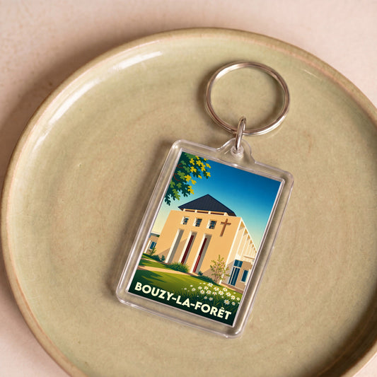 Porte-clés souvenir de la ville de Bouzy-la-Forêt avec une illustration stylisée de son église.