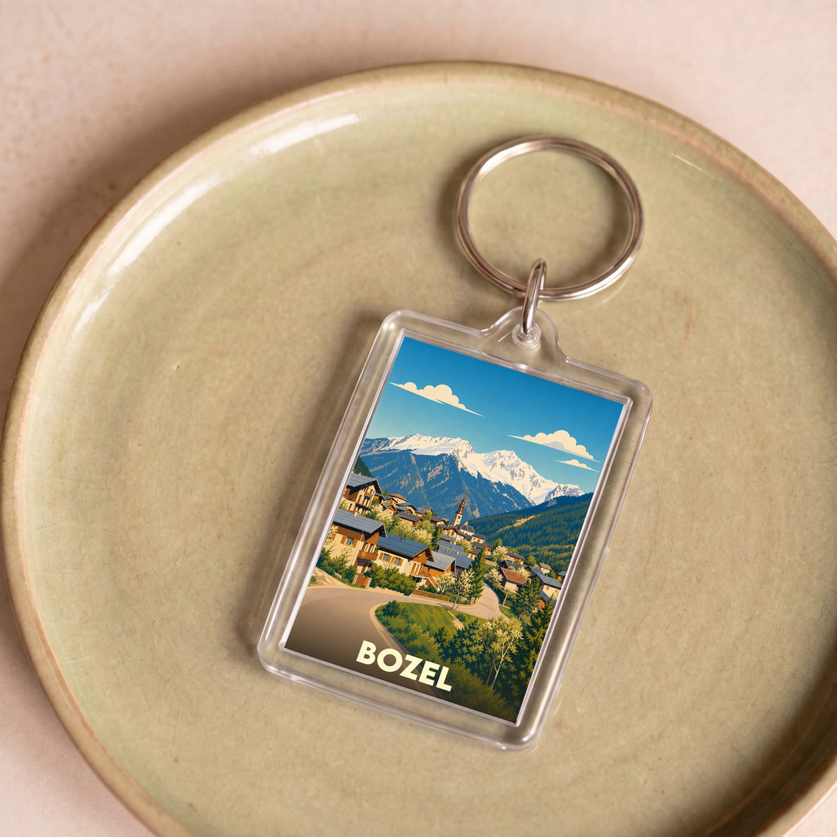 Porte-clés souvenir de la ville de Bozel avec une illustration stylisée de montagne.