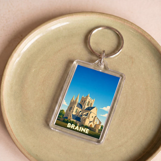 Porte-clés souvenir de la ville de Braine avec une illustration stylisée de son abbatiale.
