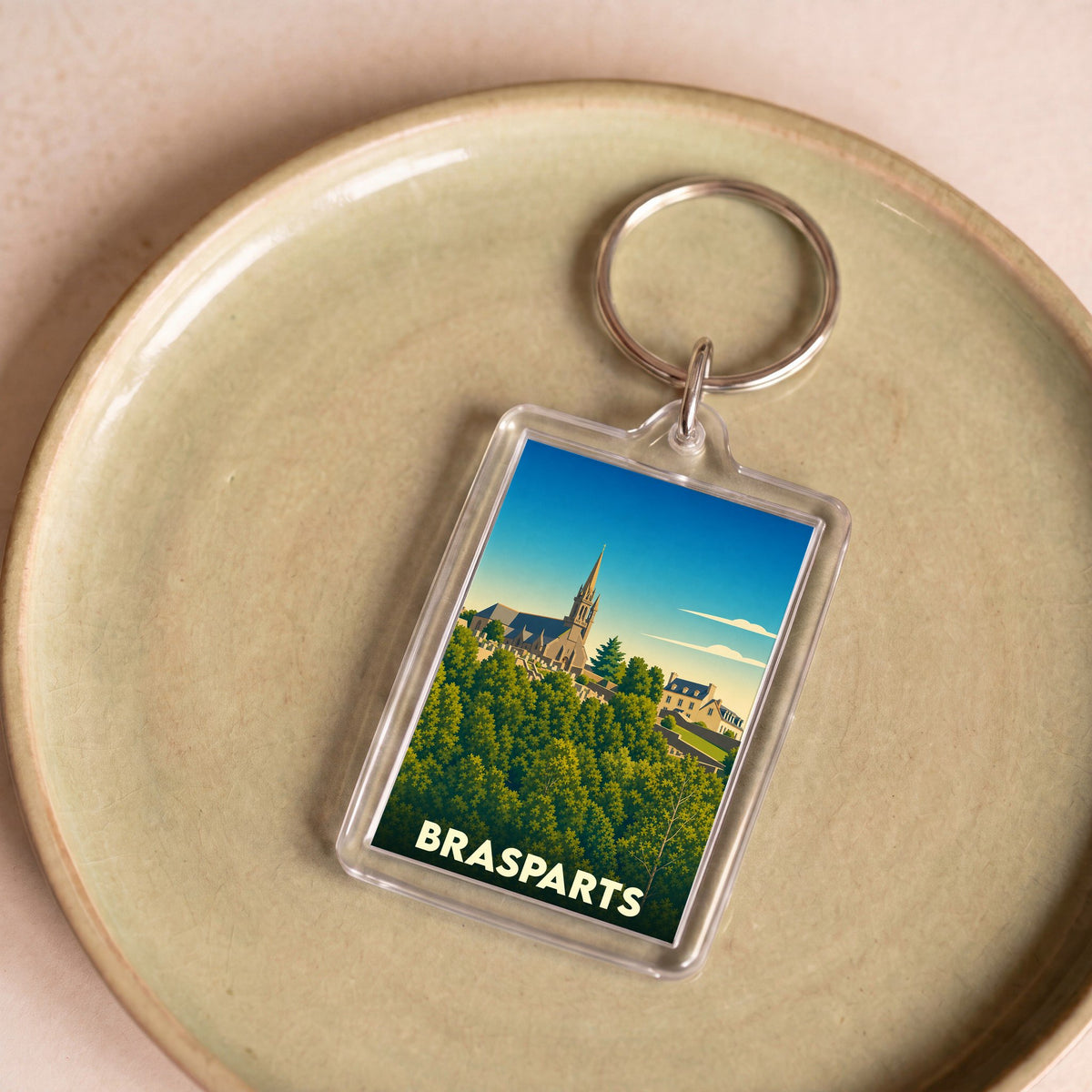 Porte-clés souvenir de la ville de Brasparts avec une illustration stylisée.