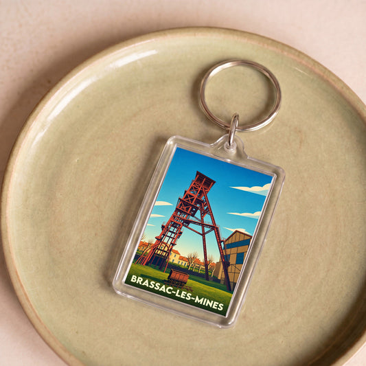 Porte-clés souvenir de la ville de Brassac-les-Mines avec une illustration stylisée d'un chevalement de mine.