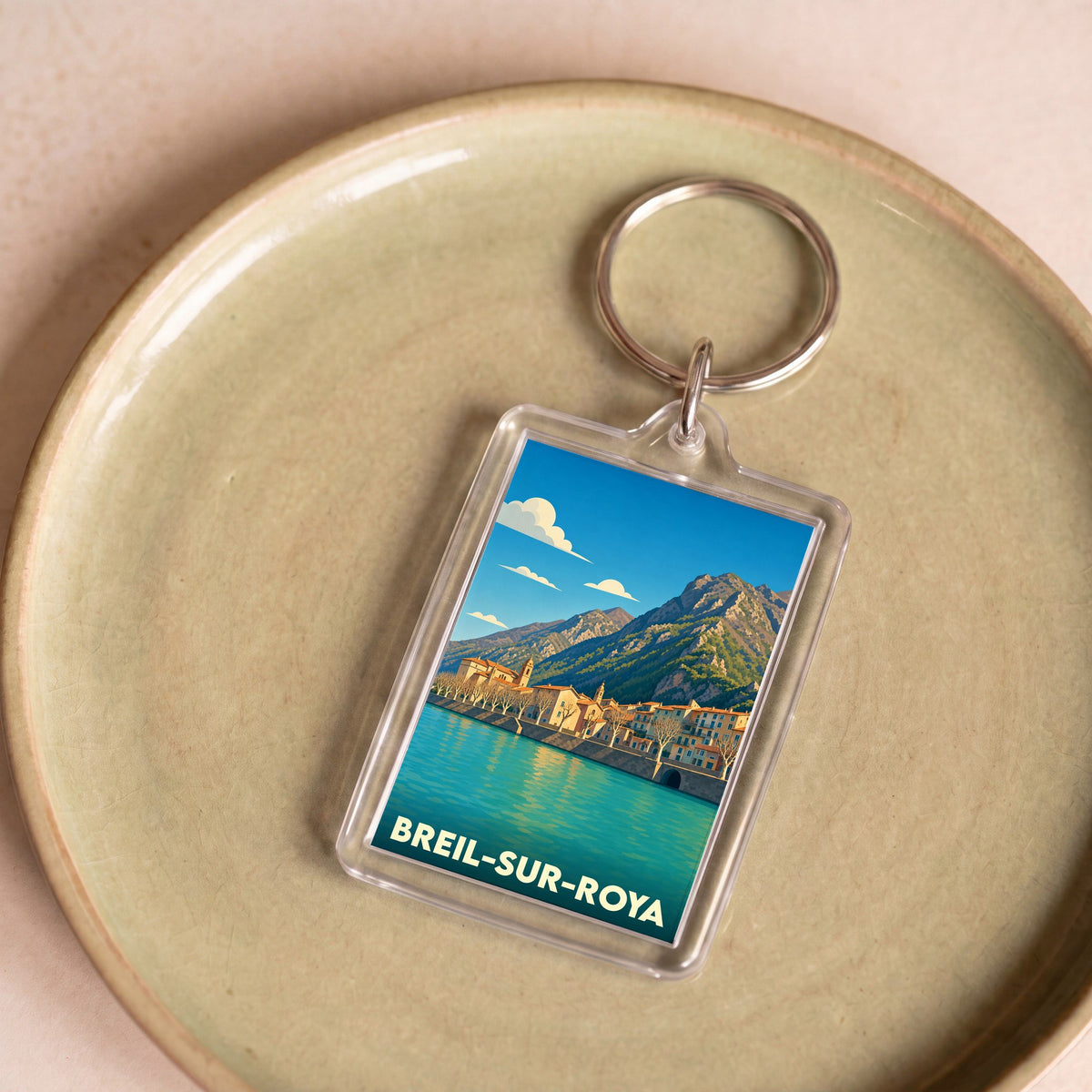 Porte-clés souvenir de la ville de Breil-sur-Roya avec une illustration stylisée.