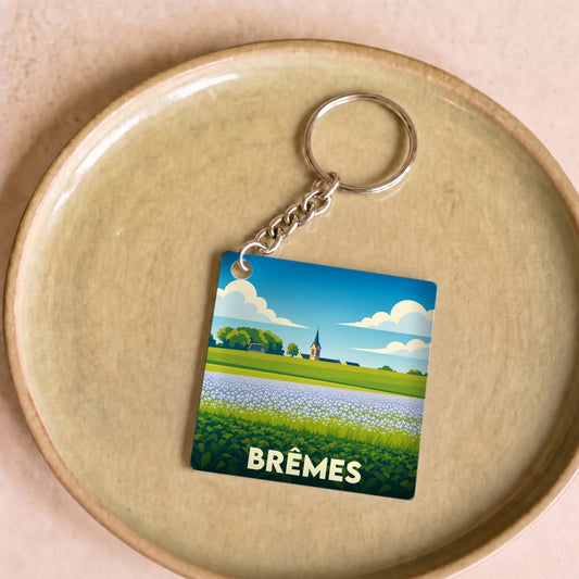 Porte-clés souvenir de la ville de Brêmes avec une illustration stylisée de paysages.