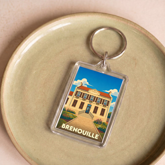 Porte-clés souvenir de la ville de Brenouille avec une illustration stylisée de sa mairie.