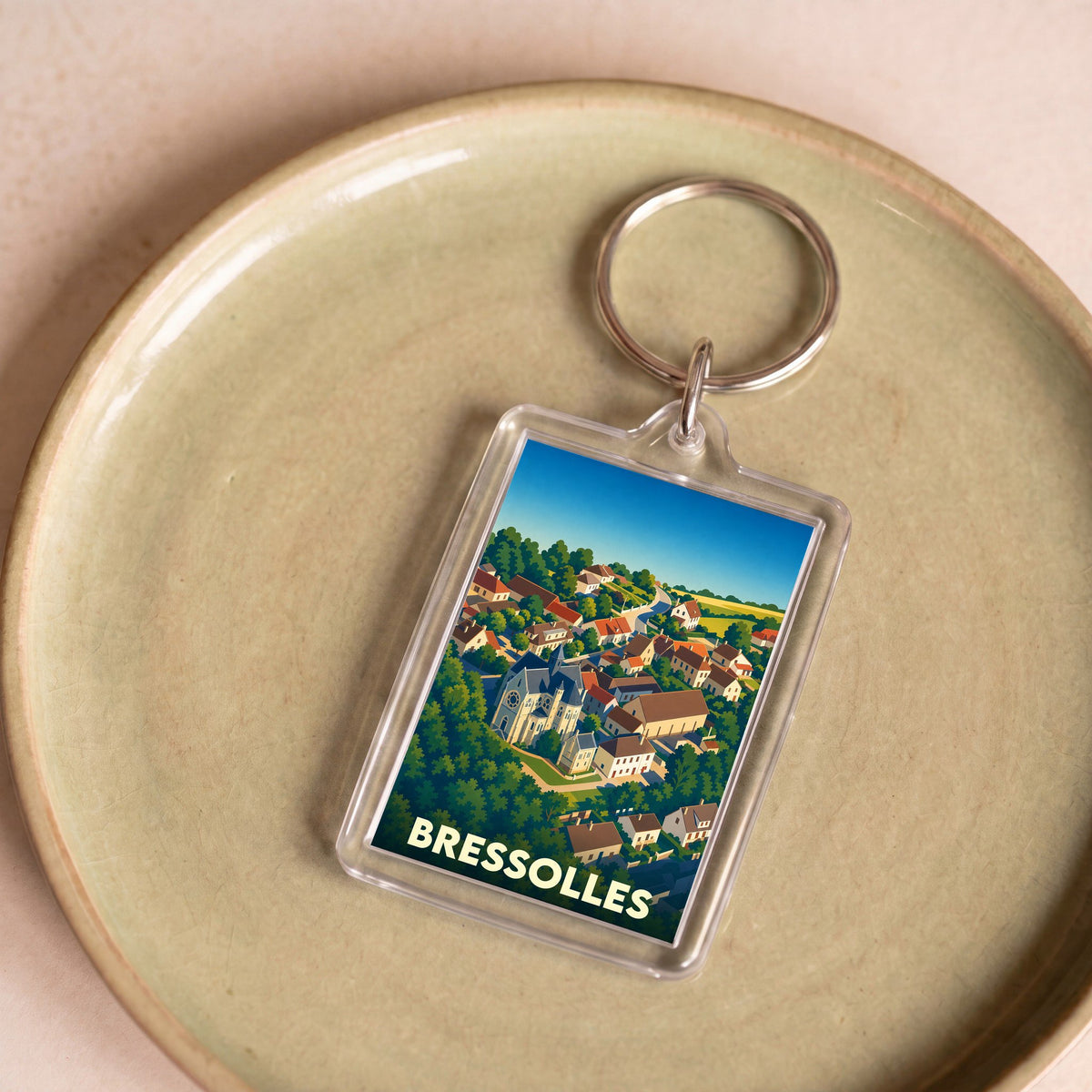 Porte-clés souvenir de la ville de Bressolles avec une illustration stylisée.