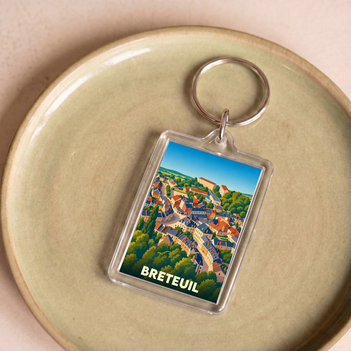 Porte-clés souvenir de la ville de Breteuil avec une illustration stylisée.