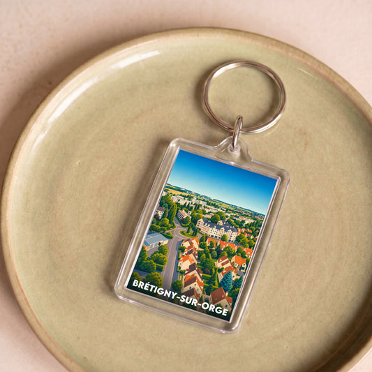 Porte-clés souvenir de la ville de Brétigny-sur-Orge avec une vue aérienne illustrée.