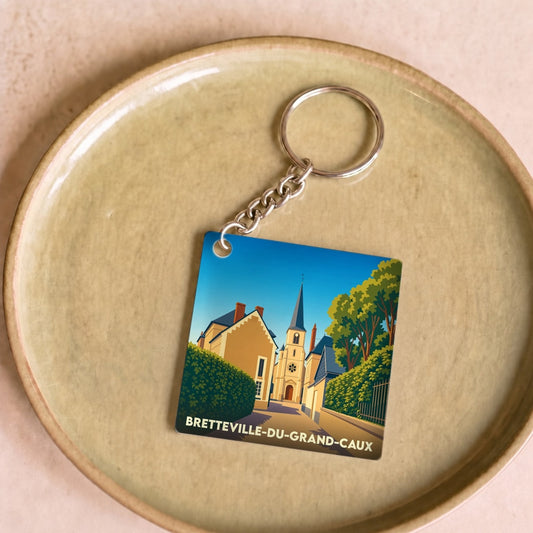 Porte-clés souvenir de la ville de Bretteville-du-Grand-Caux avec une illustration stylisée.
