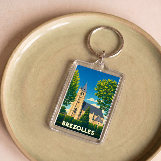 Porte-clés souvenir de la ville de Brezolles avec une illustration stylisée de son église.