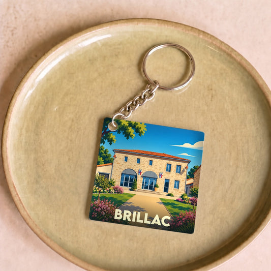 Porte-clés souvenir de la ville de Brillac avec une illustration stylisée.