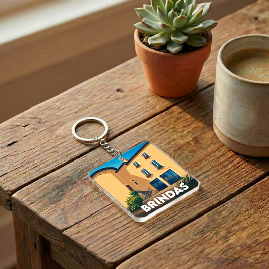 Porte-clés souvenir de la ville de Brindas avec une illustration stylisée d'un bâtiment local.